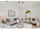 Bright living room featuring modern decor, a ceiling fan, and a view to the exterior through an arched window at 3728 Cypress Meadows Rd, Tampa, FL 33624