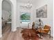 Well-lit living room featuring stylish decor, modern furnishings, and sliding glass doors to the pool area at 3728 Cypress Meadows Rd, Tampa, FL 33624