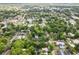 Expansive aerial view showcases a neighborhood with tree-lined streets and a mix of residential homes and local amenities at 37401 Magnolia Ave, Dade City, FL 33523