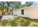Backyard featuring a new fence, grass, and a concrete patio with outdoor seating at 37401 Magnolia Ave, Dade City, FL 33523