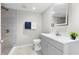 Bathroom featuring a gray vanity, a toilet and a shower with gray tile at 37401 Magnolia Ave, Dade City, FL 33523