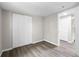 Bedroom featuring wood-look flooring, a closet, neutral walls, and multiple doorways at 37401 Magnolia Ave, Dade City, FL 33523