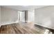 Bedroom with wood-look flooring, a closet, neutral walls, and multiple doorways at 37401 Magnolia Ave, Dade City, FL 33523