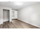 Neutral bedroom offers wood-look floors, an open closet, and flows into the next room at 37401 Magnolia Ave, Dade City, FL 33523