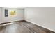 Bedroom featuring wood-look flooring, a window and neutral paint at 37401 Magnolia Ave, Dade City, FL 33523