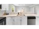 Modern kitchen with light countertops, white cabinetry, and a stainless steel dishwasher at 37401 Magnolia Ave, Dade City, FL 33523