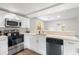Modern kitchen with stainless steel appliances, white cabinetry, and light countertops at 37401 Magnolia Ave, Dade City, FL 33523