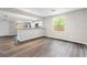 Open-concept living area with hardwood flooring leading into the kitchen at 37401 Magnolia Ave, Dade City, FL 33523