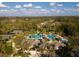 Aerial view showcasing the community's resort-style pools, splash pad, clubhouse, and tennis courts at 3844 Silverlake Way, Wesley Chapel, FL 33544