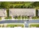 An aerial view of a townhome community featuring well-kept landscaping and street parking at 3844 Silverlake Way, Wesley Chapel, FL 33544