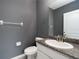 Stylish half bathroom featuring granite countertops, modern fixtures, and neutral paint at 3844 Silverlake Way, Wesley Chapel, FL 33544