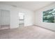 Bedroom with carpet, large window, and entrance to a walk in closet and bathroom at 3844 Silverlake Way, Wesley Chapel, FL 33544