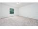 Spacious carpeted bedroom with a large window for natural light at 3844 Silverlake Way, Wesley Chapel, FL 33544