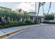 A beautifully landscaped community clubhouse featuring palm trees and a circular turret at 3844 Silverlake Way, Wesley Chapel, FL 33544