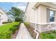 Stylish home exterior with brick-lined walkway, manicured landscaping, and neutral-toned facade at 3844 Silverlake Way, Wesley Chapel, FL 33544