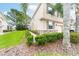 Beautifully landscaped home featuring manicured bushes, green lawn, and modern exterior accents at 3844 Silverlake Way, Wesley Chapel, FL 33544