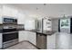 Well-equipped kitchen featuring stainless steel appliances, granite countertops, and a breakfast bar at 3844 Silverlake Way, Wesley Chapel, FL 33544