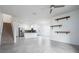 Open-concept living space showcasing modern shelving, a staircase, and seamless flow to the kitchen at 3844 Silverlake Way, Wesley Chapel, FL 33544
