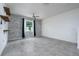 Spacious room featuring a decorative wall, a ceiling fan, and tile floors at 3844 Silverlake Way, Wesley Chapel, FL 33544