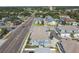 Aerial view capturing the layout of residential buildings, roads, and surrounding foliage in an urban area at 414 Finn Way # 4, Dunedin, FL 34698