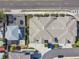 Aerial view of a residential building with a complex roof layout, surrounded by landscaping and street at 414 Finn Way # 4, Dunedin, FL 34698