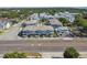 Aerial perspective of residential buildings lining a street, backed by a skyline and lush greenery at 414 Finn Way # 4, Dunedin, FL 34698