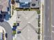 Overhead shot of a residential building featuring a complex roof design, adjacent to a road and greenery at 414 Finn Way # 4, Dunedin, FL 34698