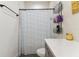 Clean bathroom with a shower featuring a striped curtain and metal storage rack at 414 Finn Way # 4, Dunedin, FL 34698