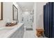 Bright bathroom showcasing a double sink vanity and glass shower with marble tiles at 414 Finn Way # 4, Dunedin, FL 34698