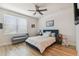 Bedroom with a ceiling fan, large window, and wood flooring at 414 Finn Way # 4, Dunedin, FL 34698