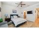 Bedroom with a TV, ceiling fan, ensuite bathroom, and ample closet space at 414 Finn Way # 4, Dunedin, FL 34698