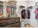 Organized walk-in closet with shelving, hanging storage, trophies and medals on display at 414 Finn Way # 4, Dunedin, FL 34698