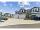 Exterior view of blue townhomes with white garage doors and a black Toyota SUV parked in the driveway at 414 Finn Way # 4, Dunedin, FL 34698