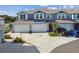 Charming townhome exterior with a well-maintained lawn, a private driveway, and a two-car garage at 414 Finn Way # 4, Dunedin, FL 34698