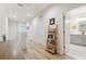 Bright hallway leading to a bathroom, with a decorative ladder and natural light, creating a welcoming space at 414 Finn Way # 4, Dunedin, FL 34698
