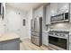Well-appointed kitchen with stainless steel appliances, stylish cabinetry, and wood-look flooring at 414 Finn Way # 4, Dunedin, FL 34698
