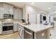 Bright kitchen with a large island, stainless steel appliances, and gray cabinets at 414 Finn Way # 4, Dunedin, FL 34698