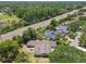 An aerial view of a landscaped home with a large back yard, a pool and lush mature trees at 4161 Rolling Springs Dr, Tampa, FL 33624