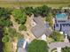 Birds-eye view of a backyard with a shed, a firepit, a seating area and an inviting pool at 4161 Rolling Springs Dr, Tampa, FL 33624