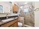 Bathroom featuring a shower with tile walls and sink with granite counter at 4161 Rolling Springs Dr, Tampa, FL 33624