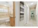 Bathroom with tub, walk-in shower, and vanity, flowing into a tiled hallway at 4161 Rolling Springs Dr, Tampa, FL 33624