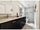 Beautifully renovated bathroom with double vanity sinks and a modern shower at 4161 Rolling Springs Dr, Tampa, FL 33624
