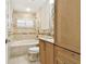 Bathroom featuring a tub with decorative tile, vanity, and storage at 4161 Rolling Springs Dr, Tampa, FL 33624