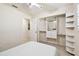 Cozy bedroom with a ceiling fan and a closet with built-in drawers and shelves at 4161 Rolling Springs Dr, Tampa, FL 33624