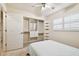 Well-lit bedroom with built-in closet shelving and a ceiling fan offers practical comfort at 4161 Rolling Springs Dr, Tampa, FL 33624