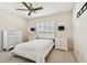 Inviting bedroom with a bed, side tables, dresser, and bright plantation shutters at 4161 Rolling Springs Dr, Tampa, FL 33624