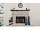 Stone fireplace with mantel and hearth topped with decor and black iron firebox at 4161 Rolling Springs Dr, Tampa, FL 33624