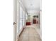 Hallway leading to a carpeted room with a popcorn machine and storage at 4161 Rolling Springs Dr, Tampa, FL 33624