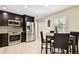 Modern kitchen features stainless steel appliances, dark cabinets, tile backsplash, and breakfast table at 4161 Rolling Springs Dr, Tampa, FL 33624