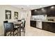 Eat-in kitchen with tile floors, stainless appliances, and dark cabinetry at 4161 Rolling Springs Dr, Tampa, FL 33624